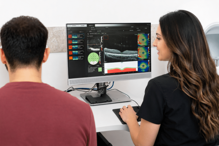 Patient reviewing a retina scan with a St. Michael's technician